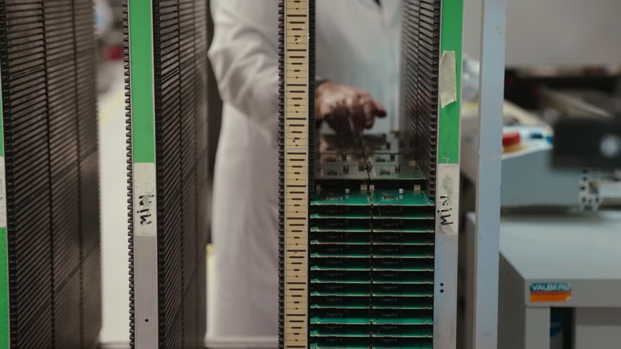 Slow motion of a technician handling circuit boards in a lab environment