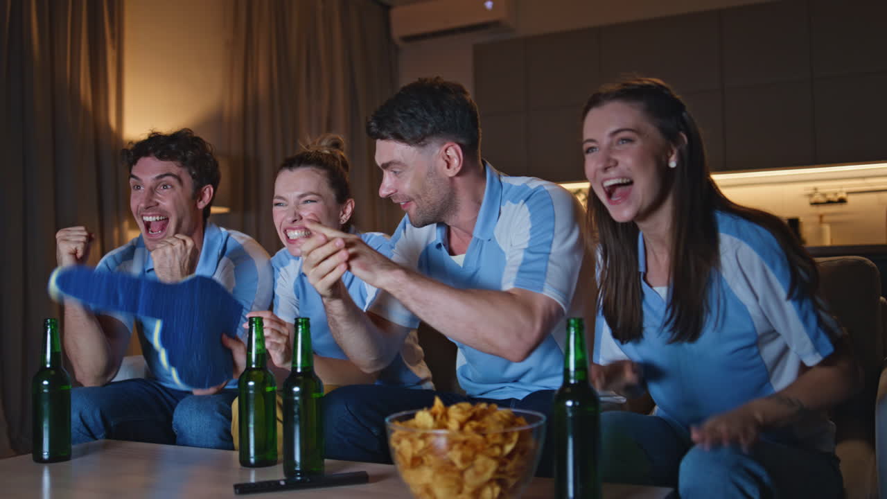 Excited friends rejoicing goal giving five at home evening closeup. Happy fans