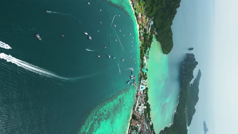 vertical aerial view of boats off touristy tonsai beach, koh phi phi, thailand