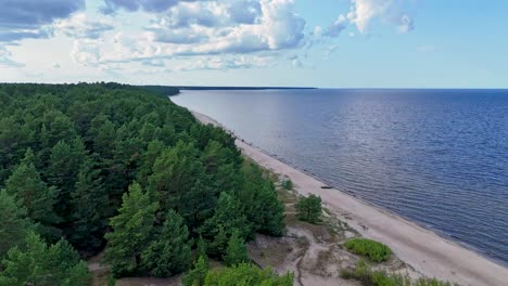 aerial drone footage of plienciems white dune in latvia on a sunny summer day. scenic baltic sea bay views, peaceful nature, and coastal landscape captured in cinematic quality