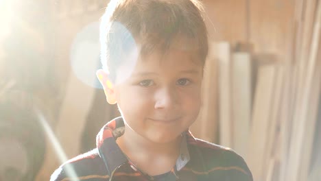 portrait of a child in a carpentry workshop.