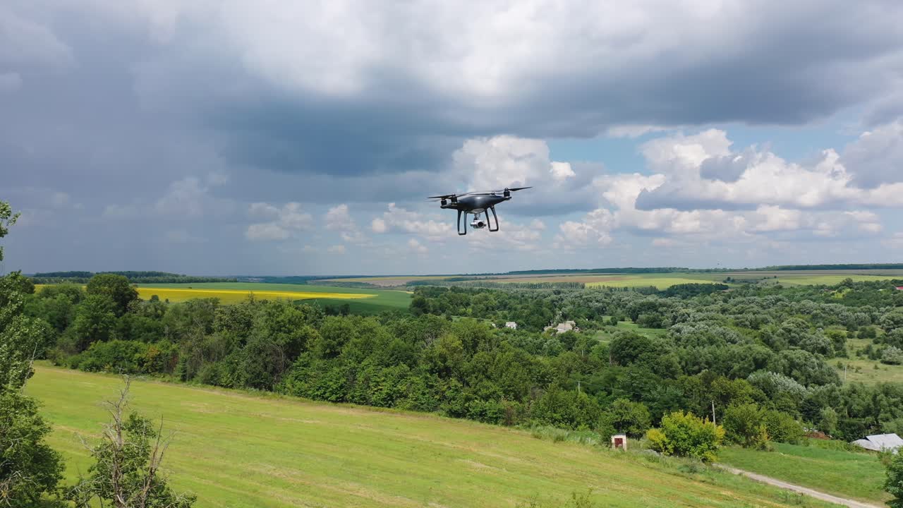 Electric drone flies in the sky. Drone quad copter with high resolution digital camera in the sky