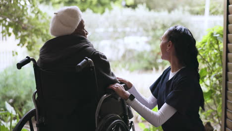 caregiver, talking and woman in a wheelchair