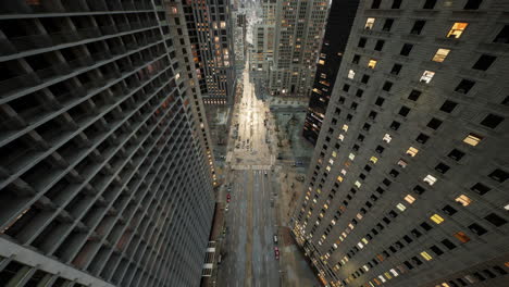 Aerial-hyperlapse-of-busy-car-traffic-in-between-Skyscrapers-city-center