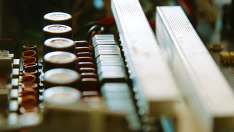 parts and components of an old dusty circuit board - rack focus
