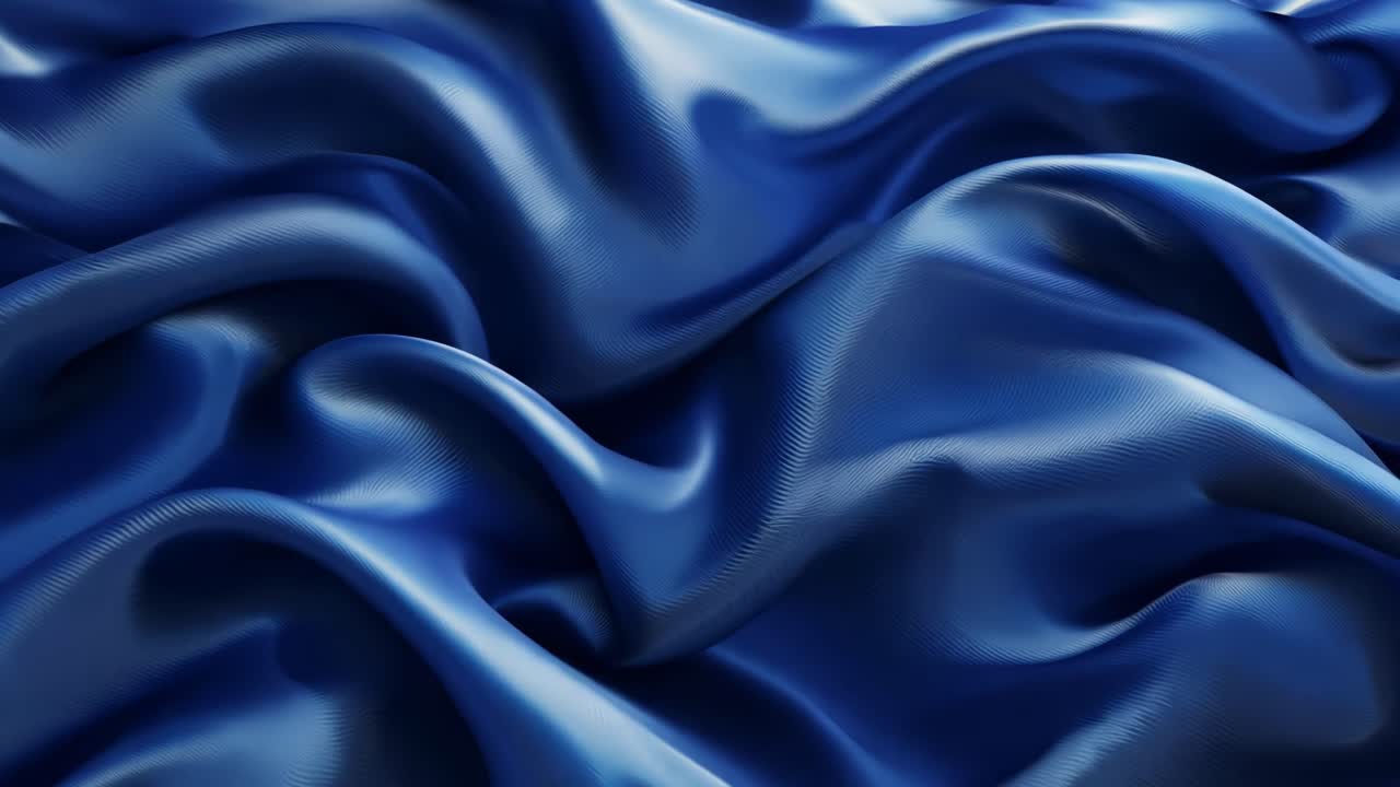 A blue fabric with a wave pattern. The fabric is flowing and has a sense of movement