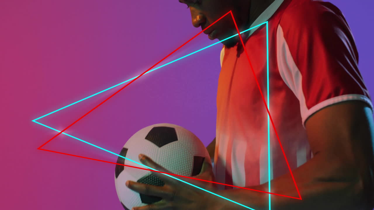 Man holding soccer ball gazing down on gradient backdrop, showcasing neon technology graphics