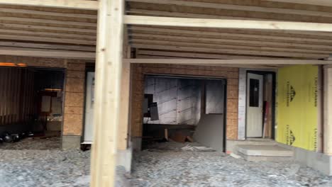 close-up of garage and entrance construction of new development neighborhood town home community in canada with wooden foundation, frame, isolation, and being complete by residential builders in city