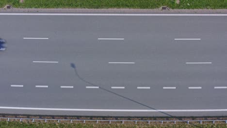 multi-lane european highway with moderate traffic trucks and cars - top-down aerial shot