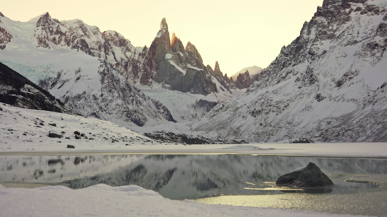 Frozen Torre Lagoon in Patagonia, El Chalten, Argentina. Winter landscape overlooking steep rocky mountain peaks