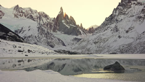 frozen torre lagoon in patagonia, el chalten, argentina. winter landscape overlooking steep rocky mountain peaks