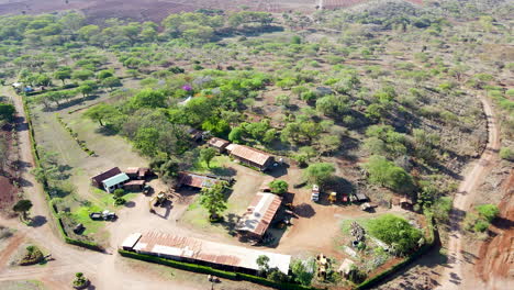 aerial of construction site and lumber mill in a beautiful african landscape