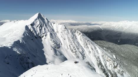 Skiers-standing-on-a-snow-capped-mountain-4k