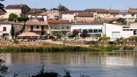 a tranquil riverside view of saint emilion