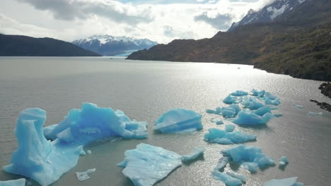 Aerial-view-of-icebergs-in-a-lake-in-the-Andes-Mountains-of-Patagonia,-Chile