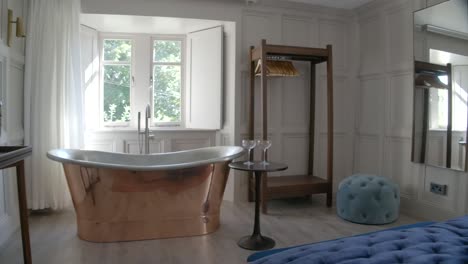 Dive-into-luxury-with-a-copper-bath-nestled-in-the-bedroom,-where-opulence-meets-relaxation-in-a-symphony-of-style-and-comfort