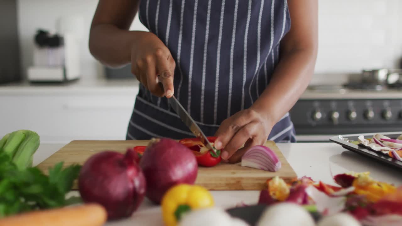 Mid section of african american woman preparing dinner in kitchen
