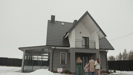 real estate agent showing house to family