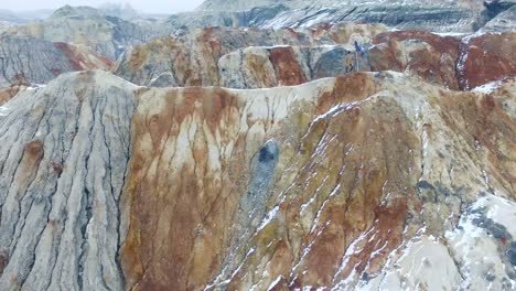 colorful winter landscape with person on mountainous terrain