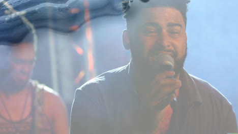 singer performing music on hazy set with mic, mixing guitar with animated stage lights