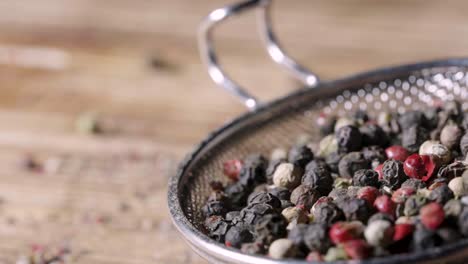 mixed peppercorns in a strainer