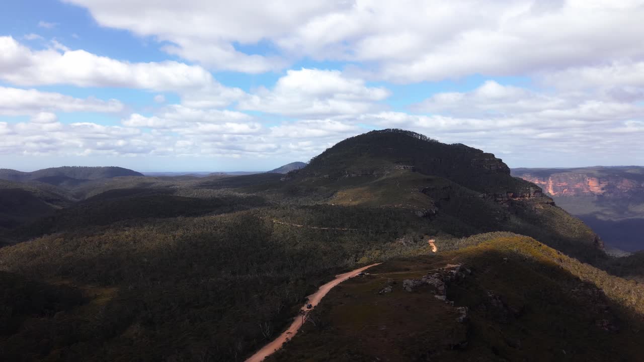 Sweeping aerial establishing over Blue Mountains ridges with valleys covered in eucalyptus gum trees, NSW Australia
