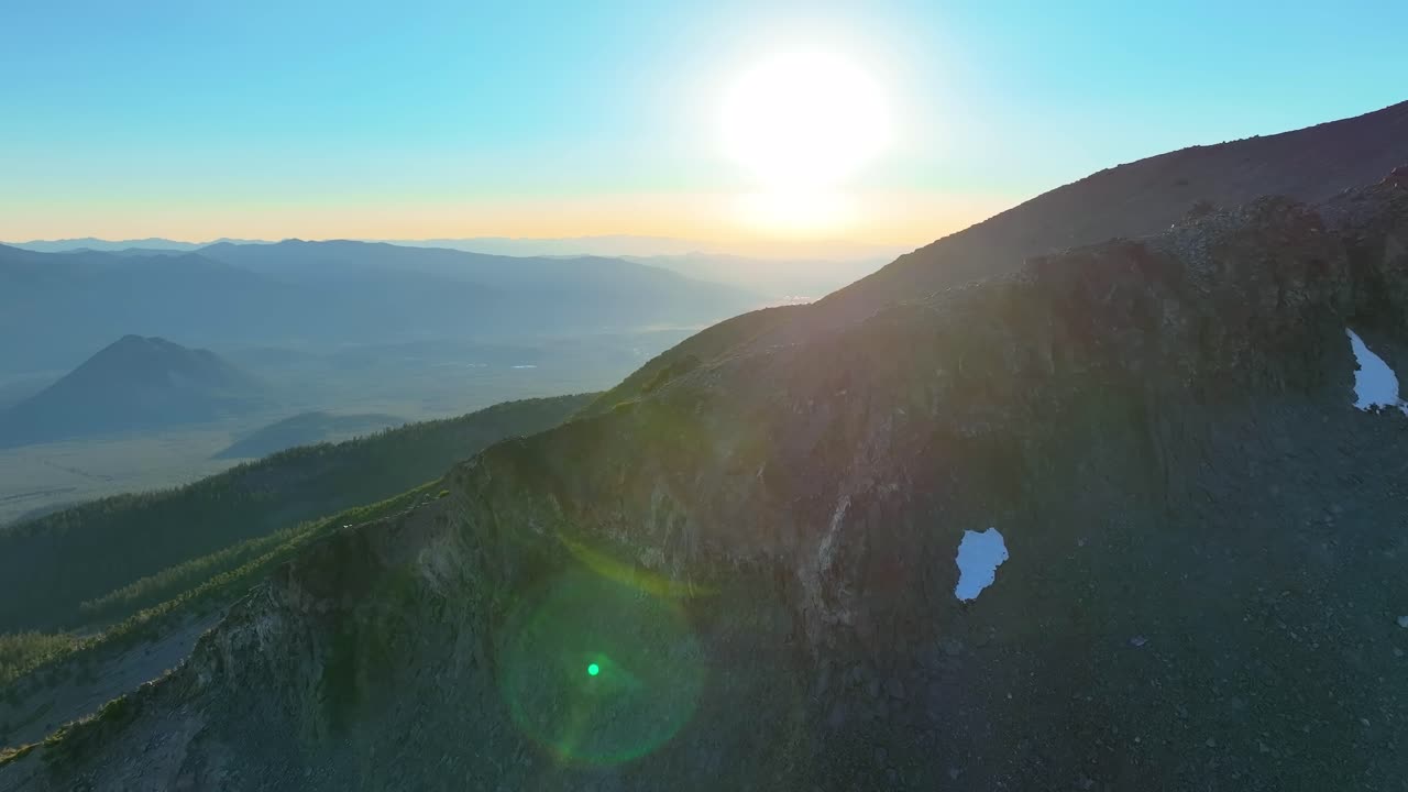 Parallax Aerial Shot Of The Peak And Rocky Terrain Of Mt Shasta At Sunrise In California, USA