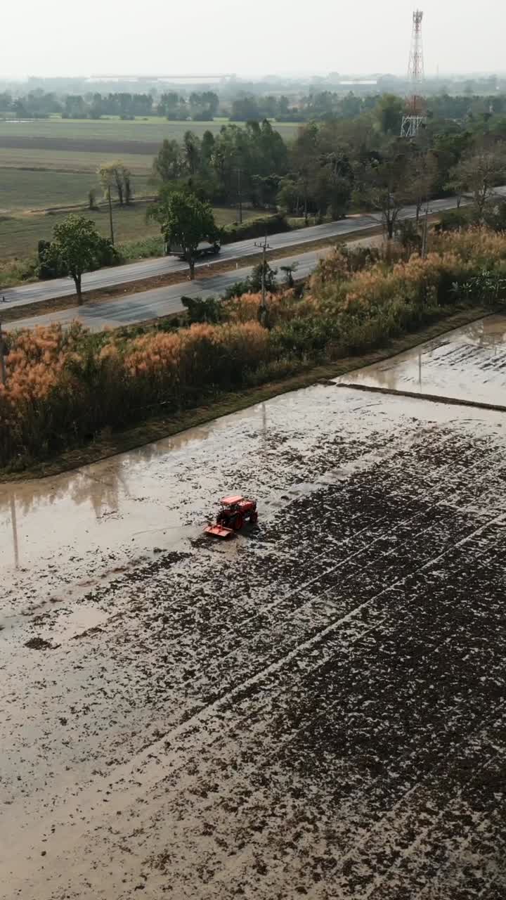 Tractor working in a rice paddy field