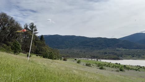 wind kite on a grassy hill next to emigrant lake
