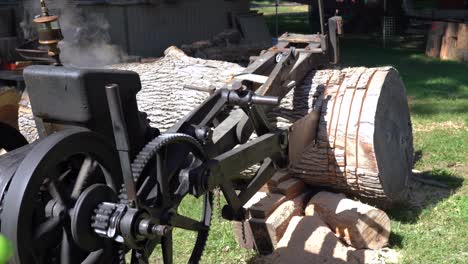 an old historic steam powered crosscut saw cutting a log during a demonstration