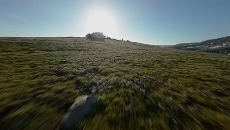 FPV-drone-flying-low-over-an-island-with-seagulls