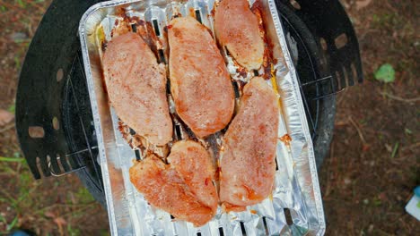 Garden-grill-overhead-top-view-of-grilled-chicken-breasts-meat,-spinning-dolly-in-shot