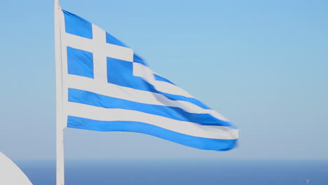 the flag of greece waves in the wind