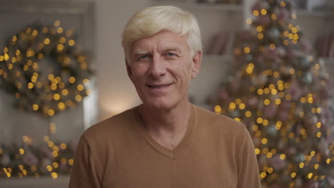 portrait of old happy man giving thumb up and looking at the camera