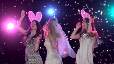 girls dancing at a party with confetti and bunny ears