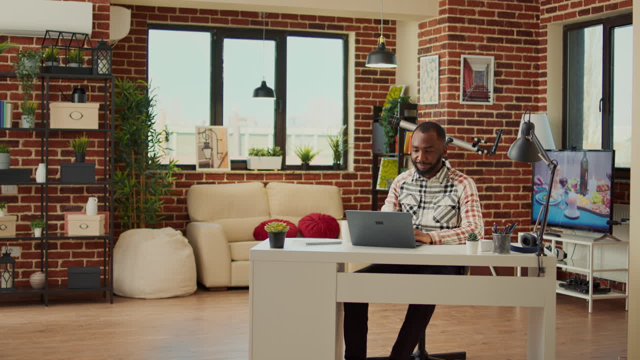 African american man working from home on laptop