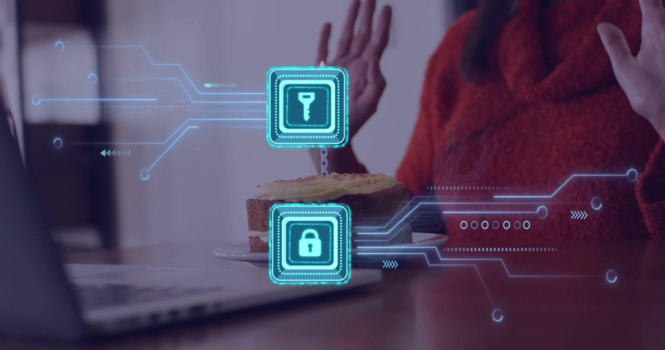 Mature woman lowering hands, blowing candle to celebrate while holographic security icons over cake