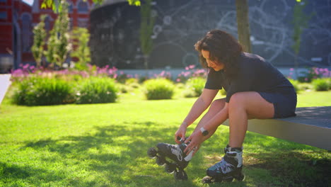 woman putting on roller skates in a park