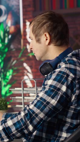 vertical video man using mouse to edit movie project footage in apartment home office