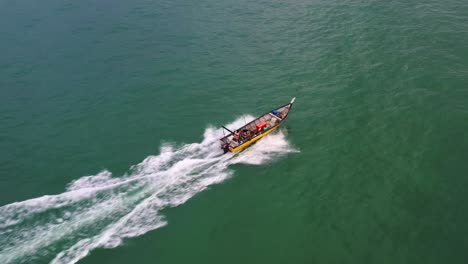 aerial birds eye view capturing small traditional fishing boat sailing on the sea, lumut, pangkor island, perak, malaysia, southeast asia