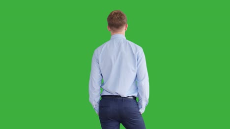 young handsome men acting in front of a green screen. blond hair, blue shirt and blue trousers. dancing, thinking, turning around and talking to the camera.