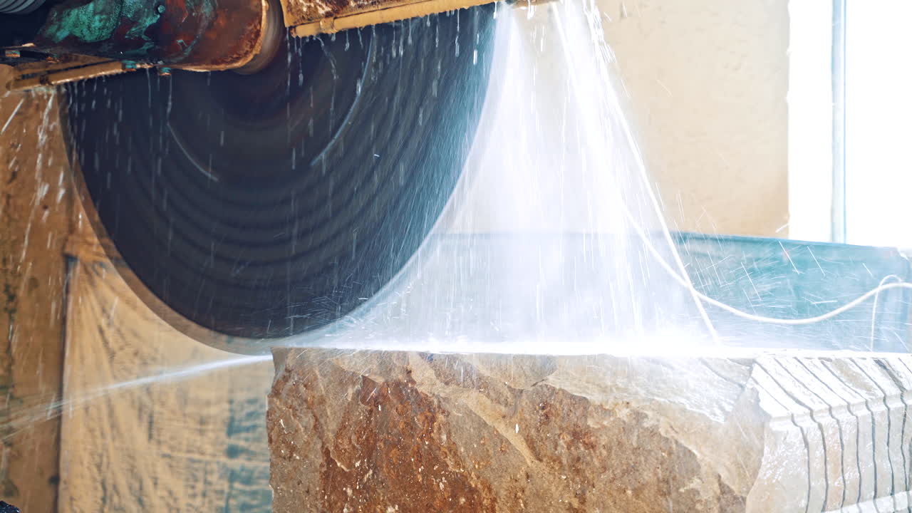 Marble cutting factory. Professional equipment cutting marble with circular saw electric construction interior