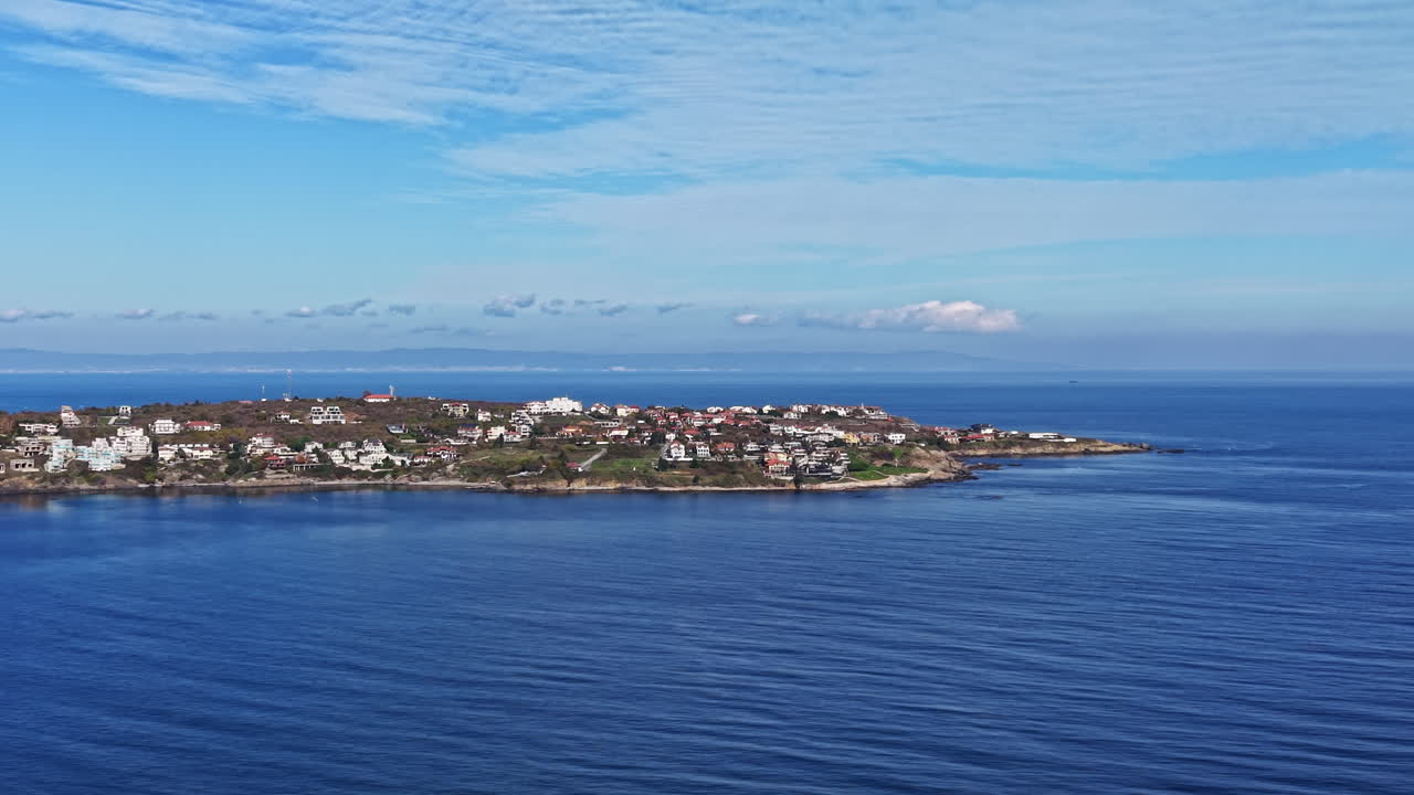 Beautiful coastal view at sunrise with calm waters and colorful houses lining the shore, highlighting nature's tranquility and scenic charm