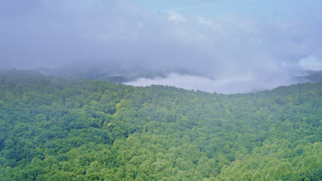 fog and mist blanket the smoky mountains as a drone floats forward