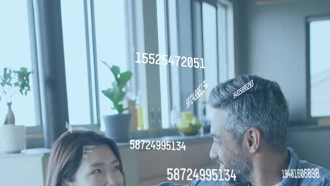 animation of data processing over diverse couple smiling