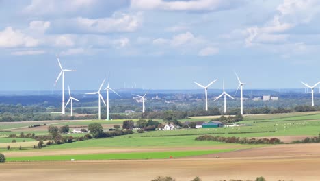 dutch landscape of farm fields, wind turbines and vehicles travelling