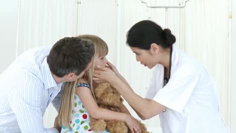 Female-doctor-talking-to-a-little-girl-and-her-father