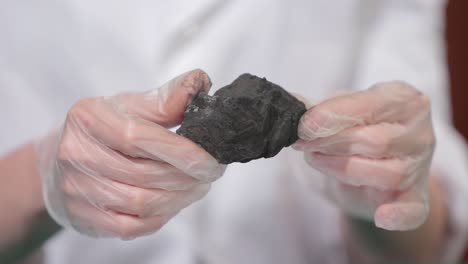 scientist examining a coal sample