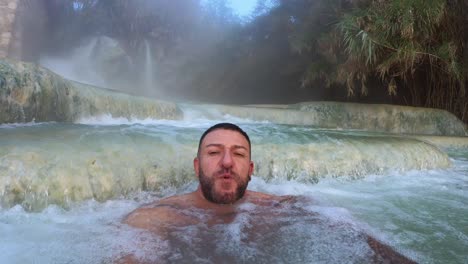 man bathing in the baths of saturnia