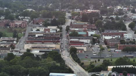 Old historic American town with Main Street and red brick houses and buildings. Traffic scene on main road. Cloudy summer day. Aerial wide shot. Waynesboro, Virginia